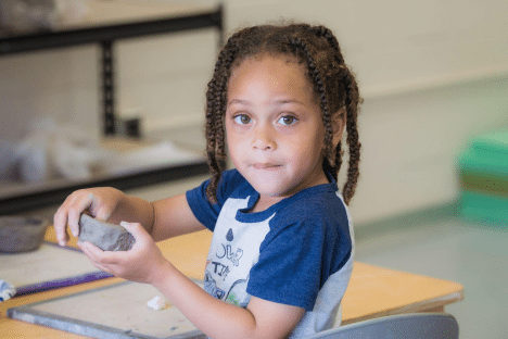 child playing with clay