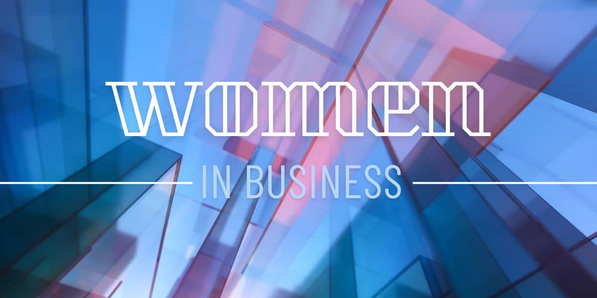 Women in Business Text in front of business building windows