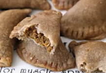 Vegan Pumpkin Pasties from “Harry Potter” Close-up of homemade pumpkin pasties, one of which has a bite taken out of it.