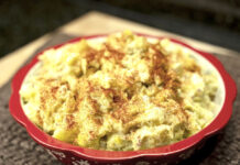 Photo of homemade potato salad dusted with paprika.