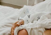 Cesarean Birth Recovery: Tips for Healing and Bonding Stock photo of a woman holding a newborn baby in a hospital bed.