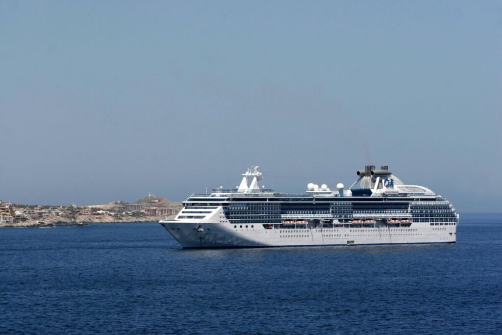 Stock photo of a cruise ship sailing on calm waters.