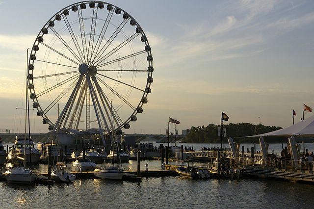 Stock photo of a large Ferris wheel on a waterfront.