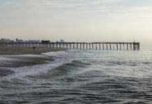 Photo of a pier at a large beach.