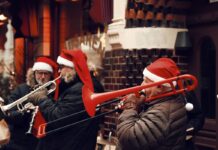 People in Santa hats playing the trombone