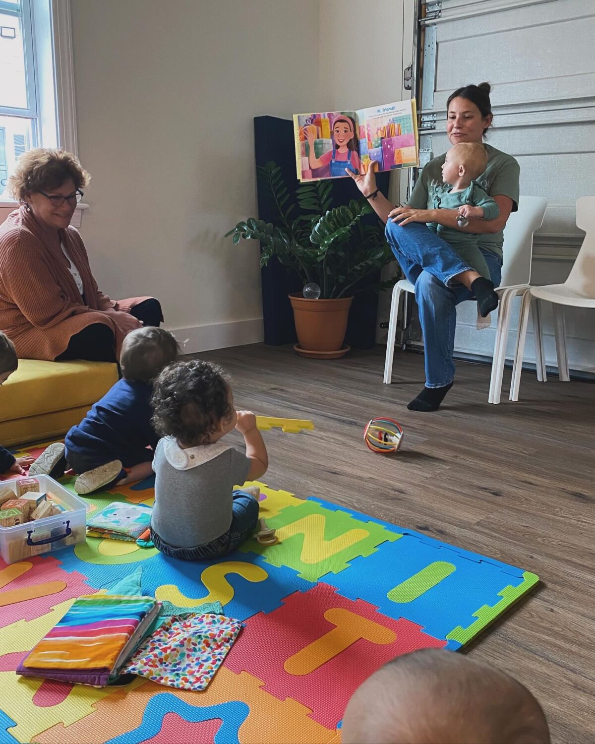 A woman reading a story to several children