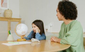 A grumpy child and an adult