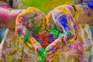 Hands covered in colored dust for Holi