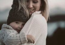 A woman hugging a baby