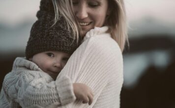A woman hugging a baby