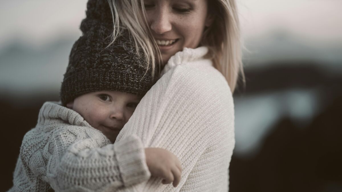 A woman hugging a baby