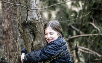 A girl hugging a tree