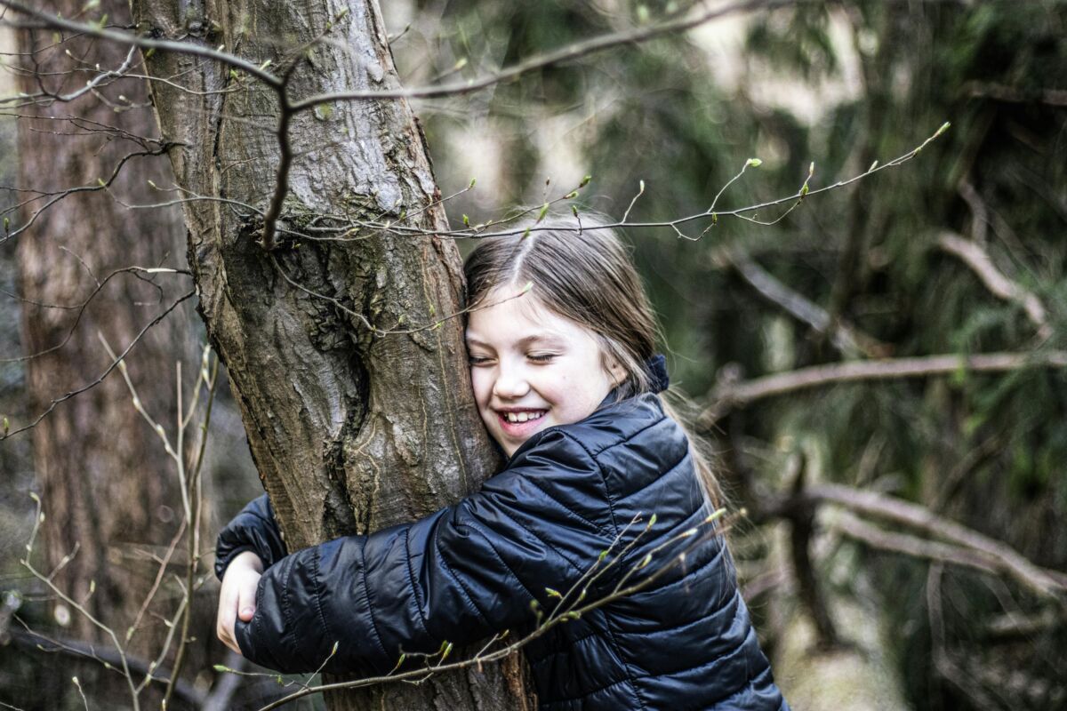 A girl hugging a tree