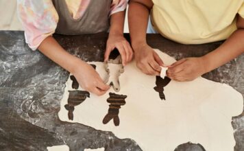 Kids cut out bunny shapes in dough as they bake in the kitchen