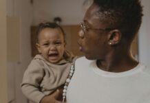 A father holding a crying baby