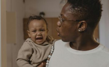 A father holding a crying baby