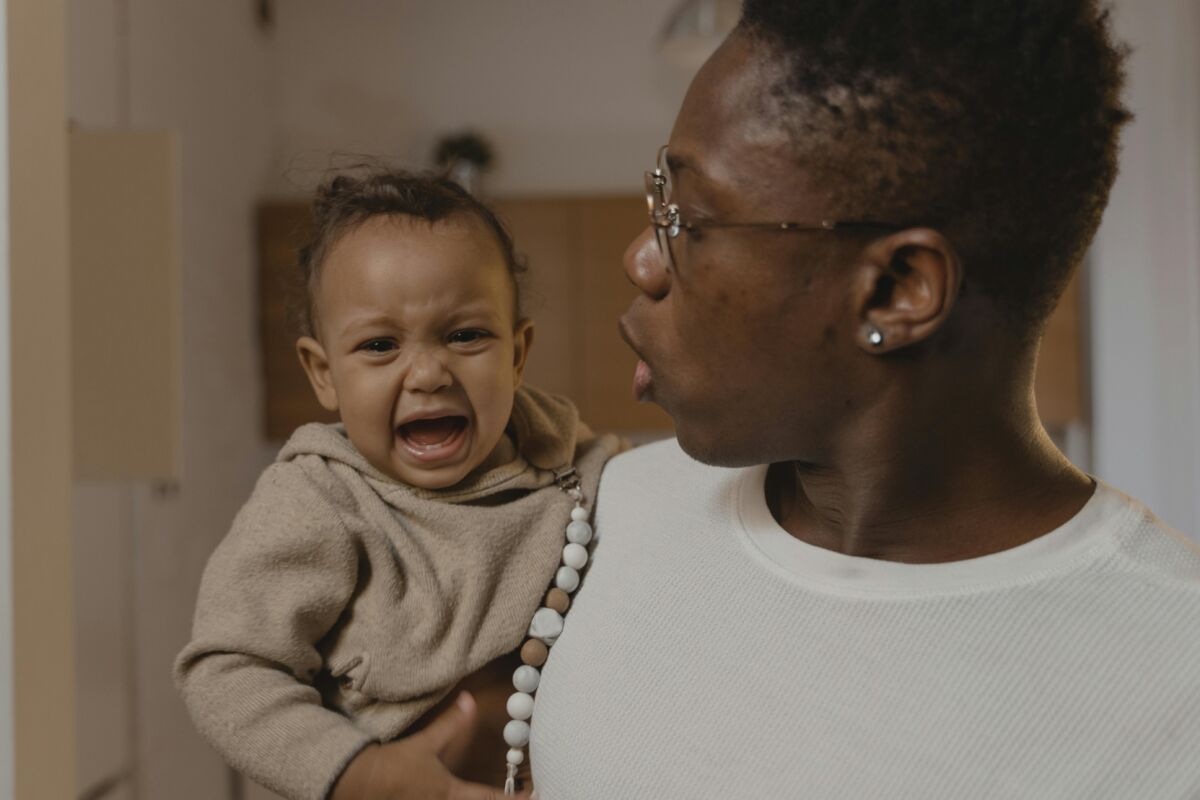 A father holding a crying baby