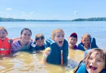 Kids swimming wearing life jackets