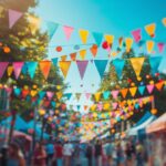Colorful bunting flags and decorations at a lively summer street festival under blue sky