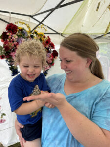 A mother and child holding a butterfly