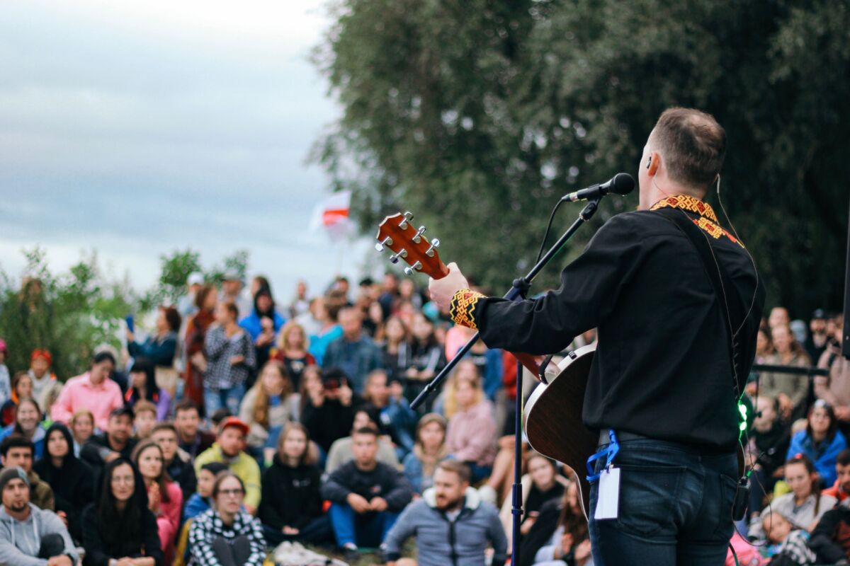 Man playing guitar at an outdoor concert