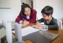 An adult tutoring a child