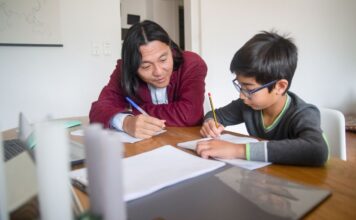 An adult tutoring a child
