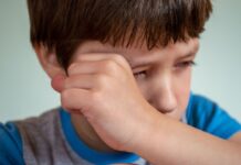 Boy wiping tears with his hand