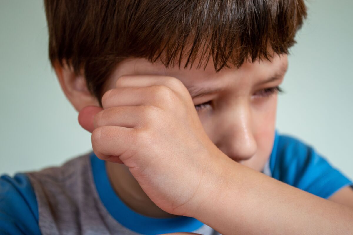 Boy wiping tears with his hand