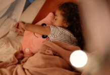 A child sleeping with a stuffed animal